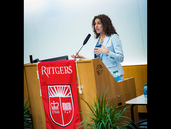 Professor and Chancellor’s Social Justice Scholar Sahar Aziz speaking at the podium